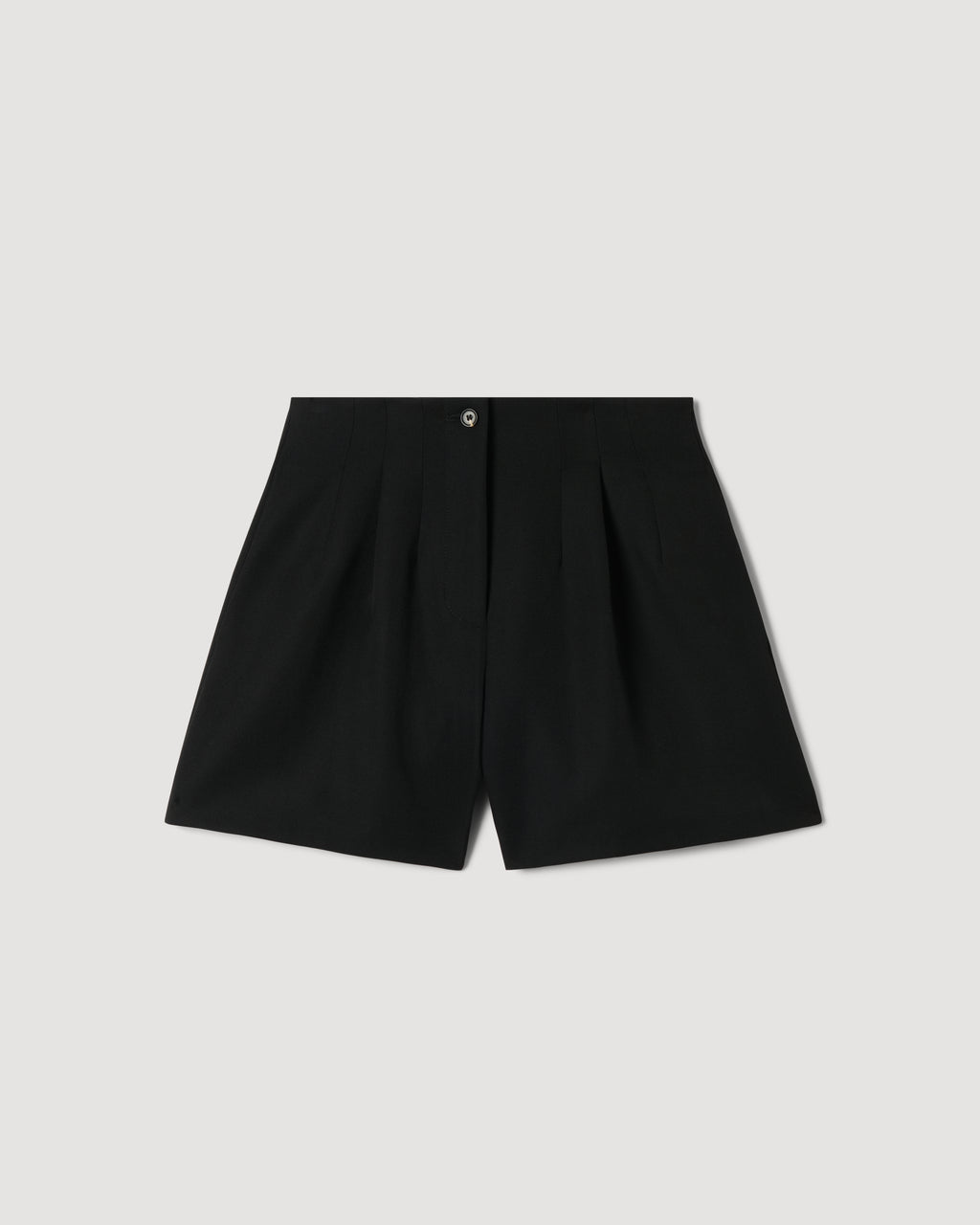 Black Tilly Short in Grain de Poudre wool packshot. High-waisted, pleated tailored shorts with a horn button front closure