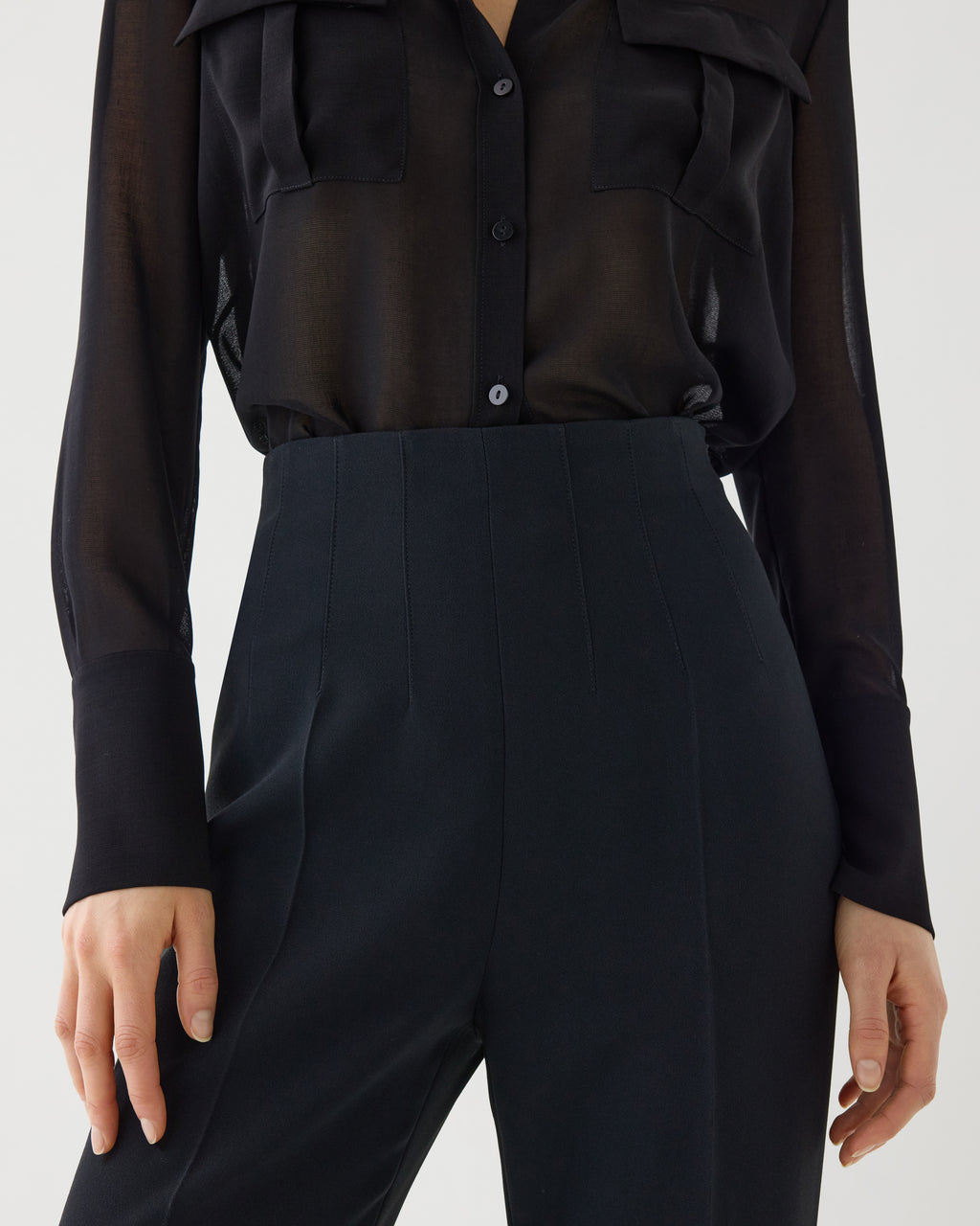 Black Naya trouser in stretch viscose crepe, showcasing a tailored bottom with a sleek, fitted design.