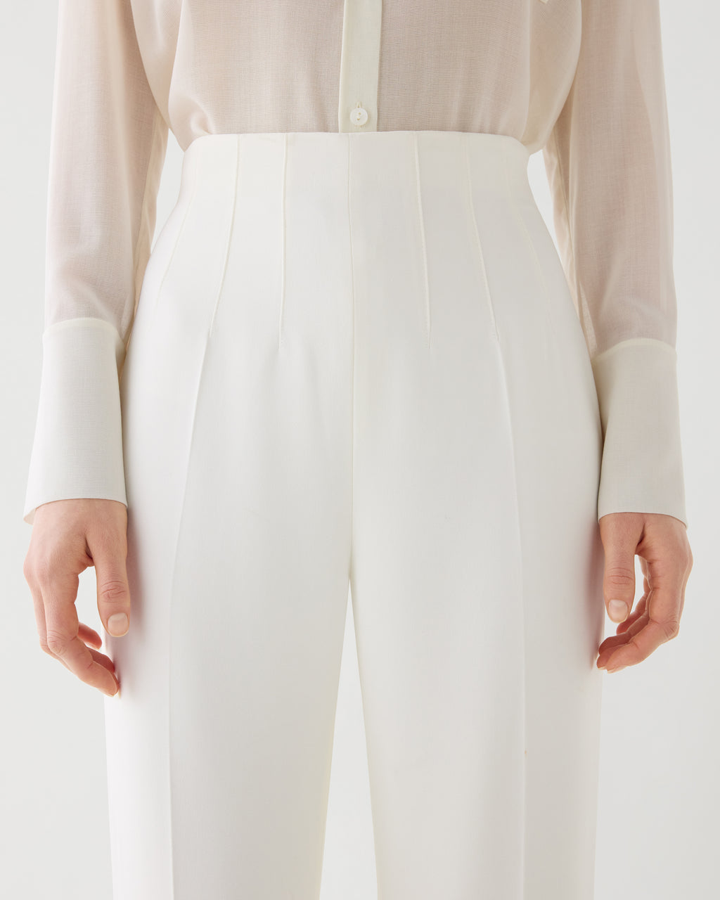 Off-white Naya trousers made from stretch viscose crepe, showcasing a sleek, tailored fit for a stylish look.