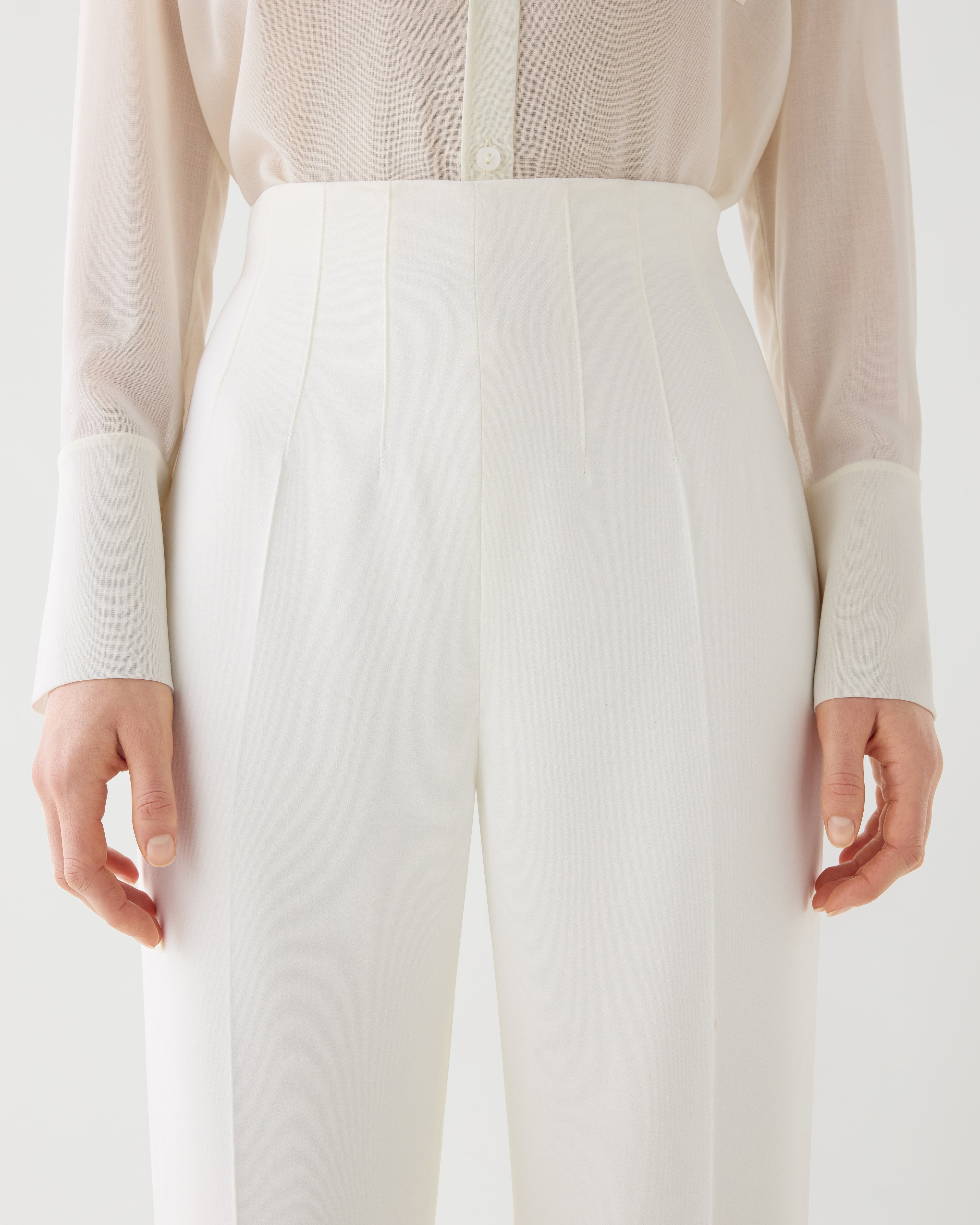 Off-white Naya trousers made from stretch viscose crepe, showcasing a sleek, tailored fit for a stylish look.