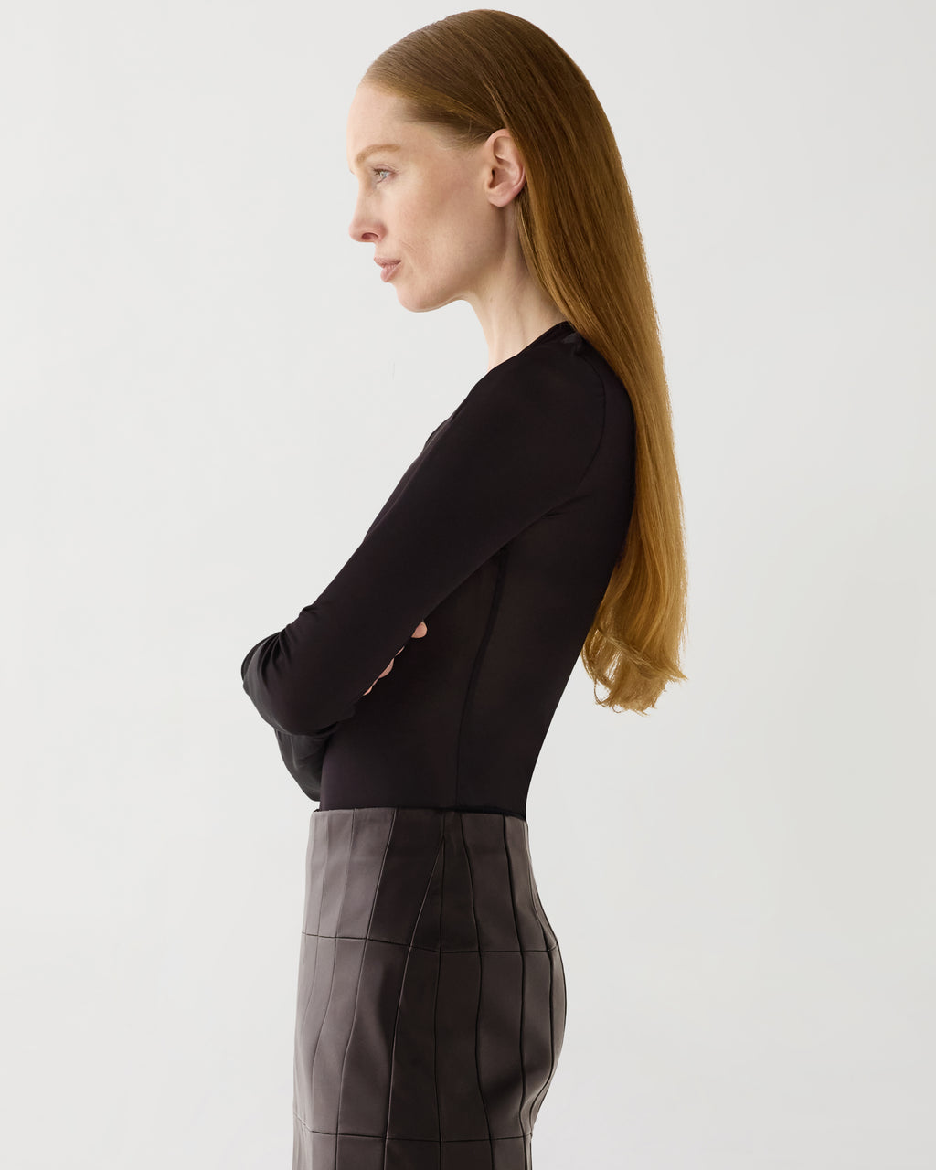 Vienna Bodysuit, sheer chocolate jersey, long sleeve, round neck, fitted luxury layering top on model