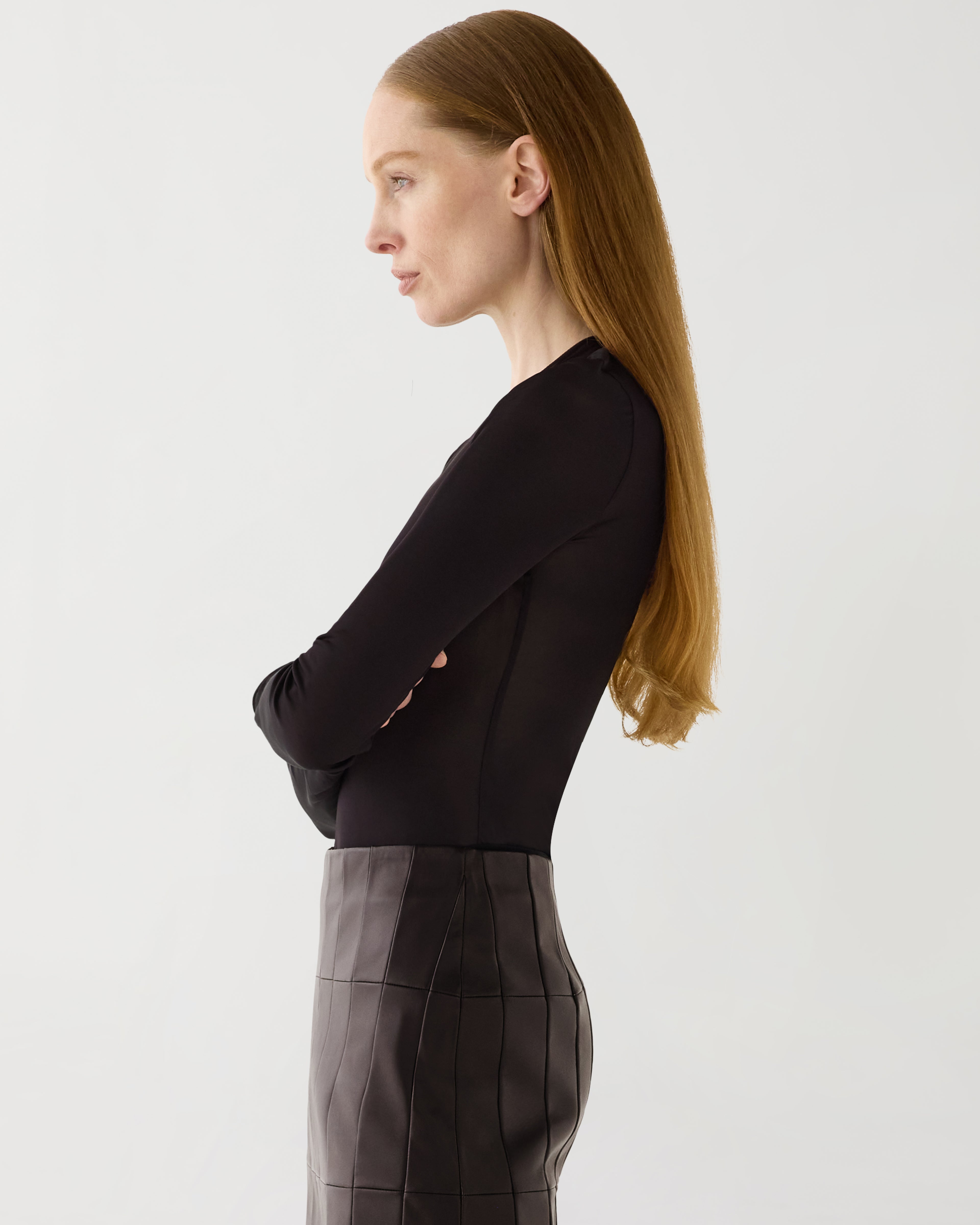 Vienna Bodysuit, sheer chocolate jersey, long sleeve, round neck, fitted luxury layering top on model