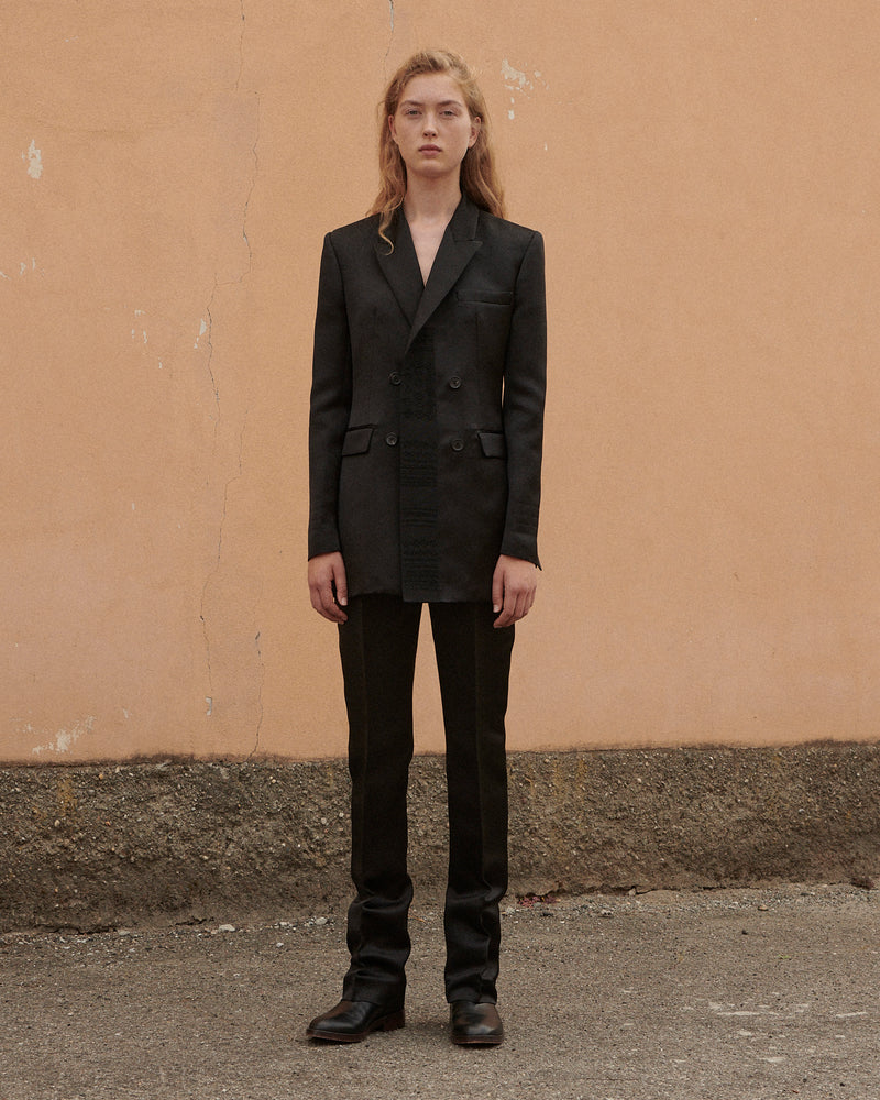 Women's deep charcoal double-breasted blazer with textured front detail, structured shoulders, and tailored straight-leg trousers
