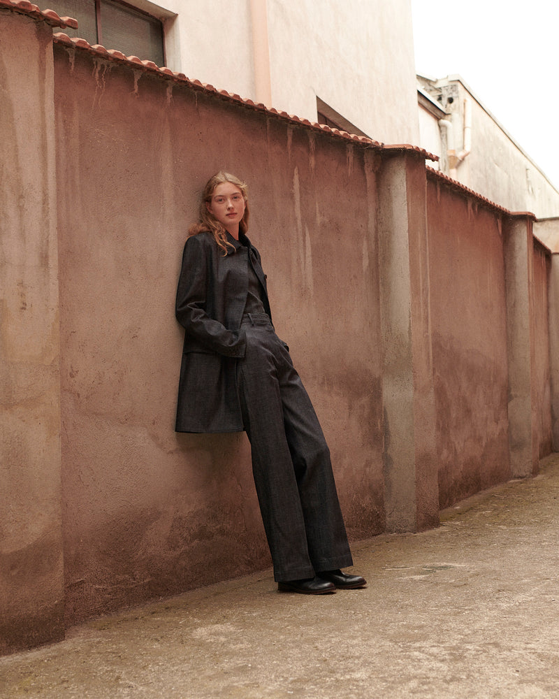 Woman in dark indigo denim oversized jacket and wide-leg trousers Luxury minimalist women's matching set
