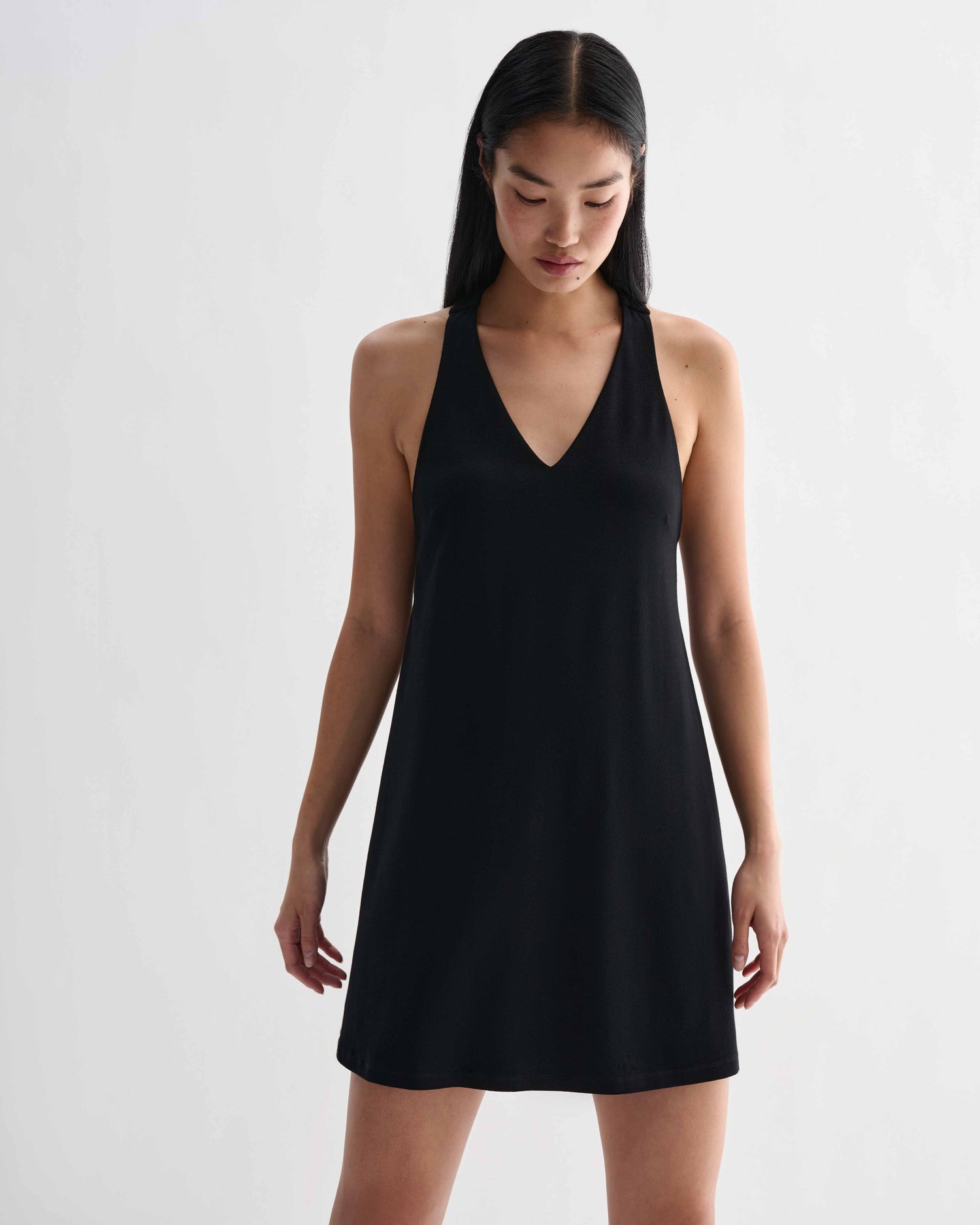 Black Vittoria dress in stretch viscose jersey by Veronica De Piante, shown on a model with a fitted silhouette and elegant design.