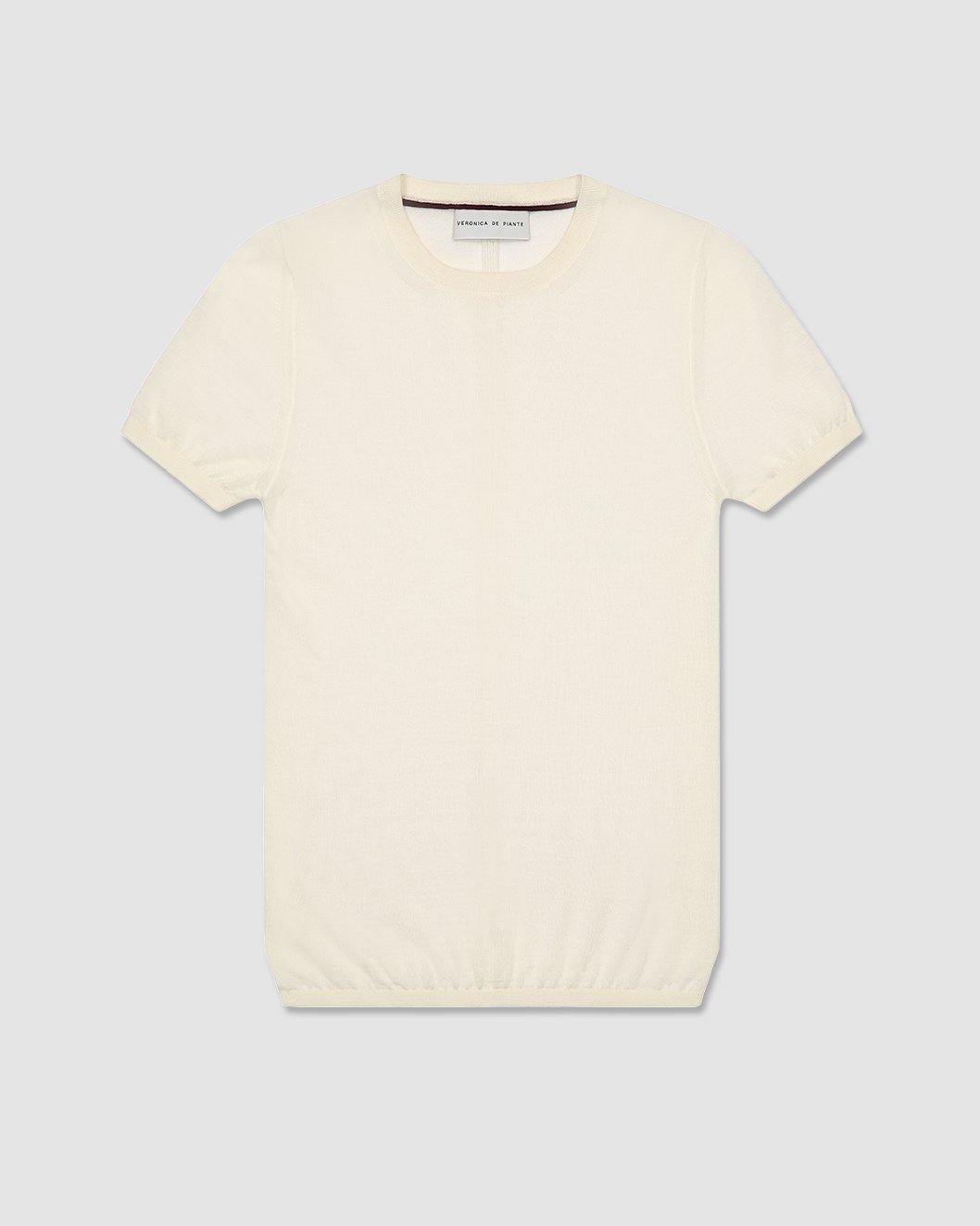 Veronica De Piante Bea Knit Top in superfine merino wool, off-white, displayed on a mannequin, showcasing its cozy, fitted design.