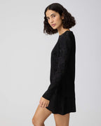 Black Carlota dress by Veronica De Piante in Viscose Jacquard fabric, showcasing elegant design and intricate textured pattern.